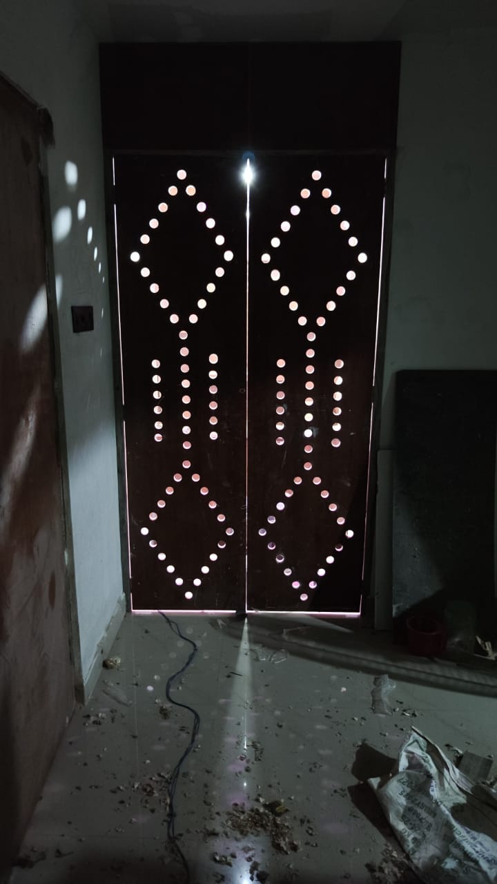 Backlit decorative double door with geometric perforations